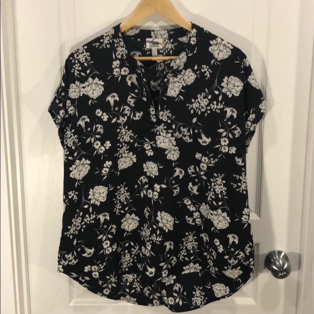 Black short sleeved top with white flowers.